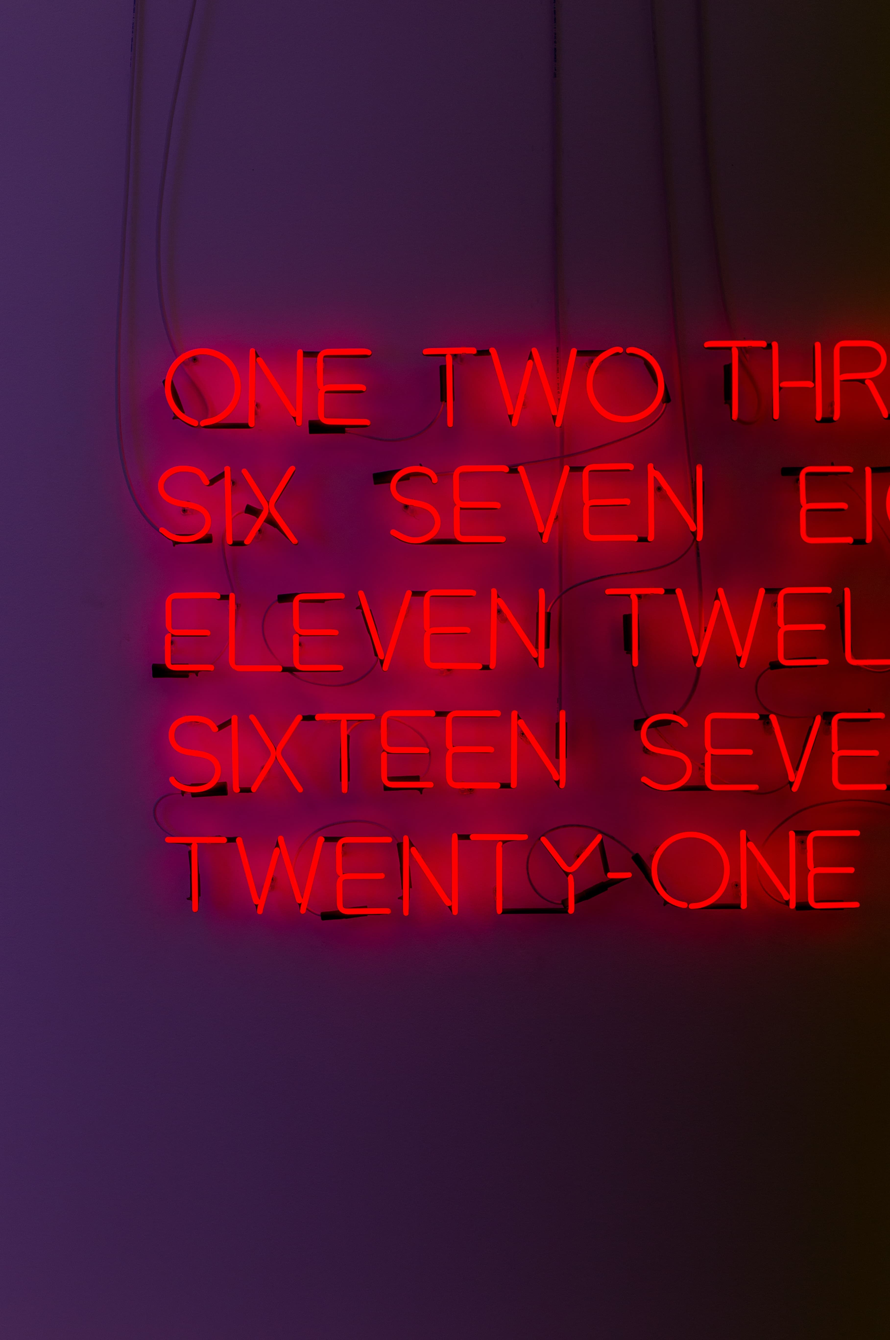 red neon numbers on a purple wall