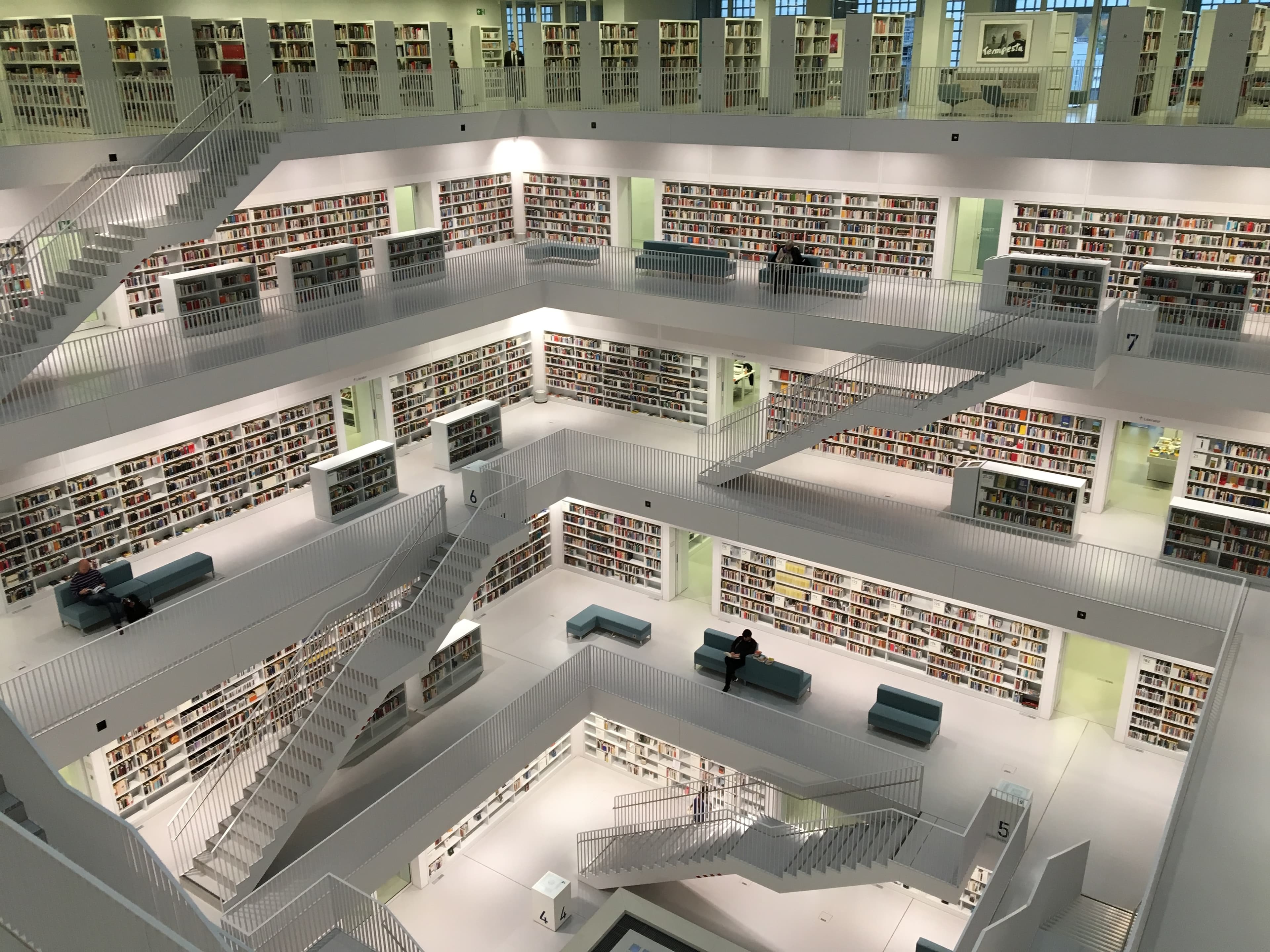 A multistory library with open modern architecture. Hundreds of books are in view.