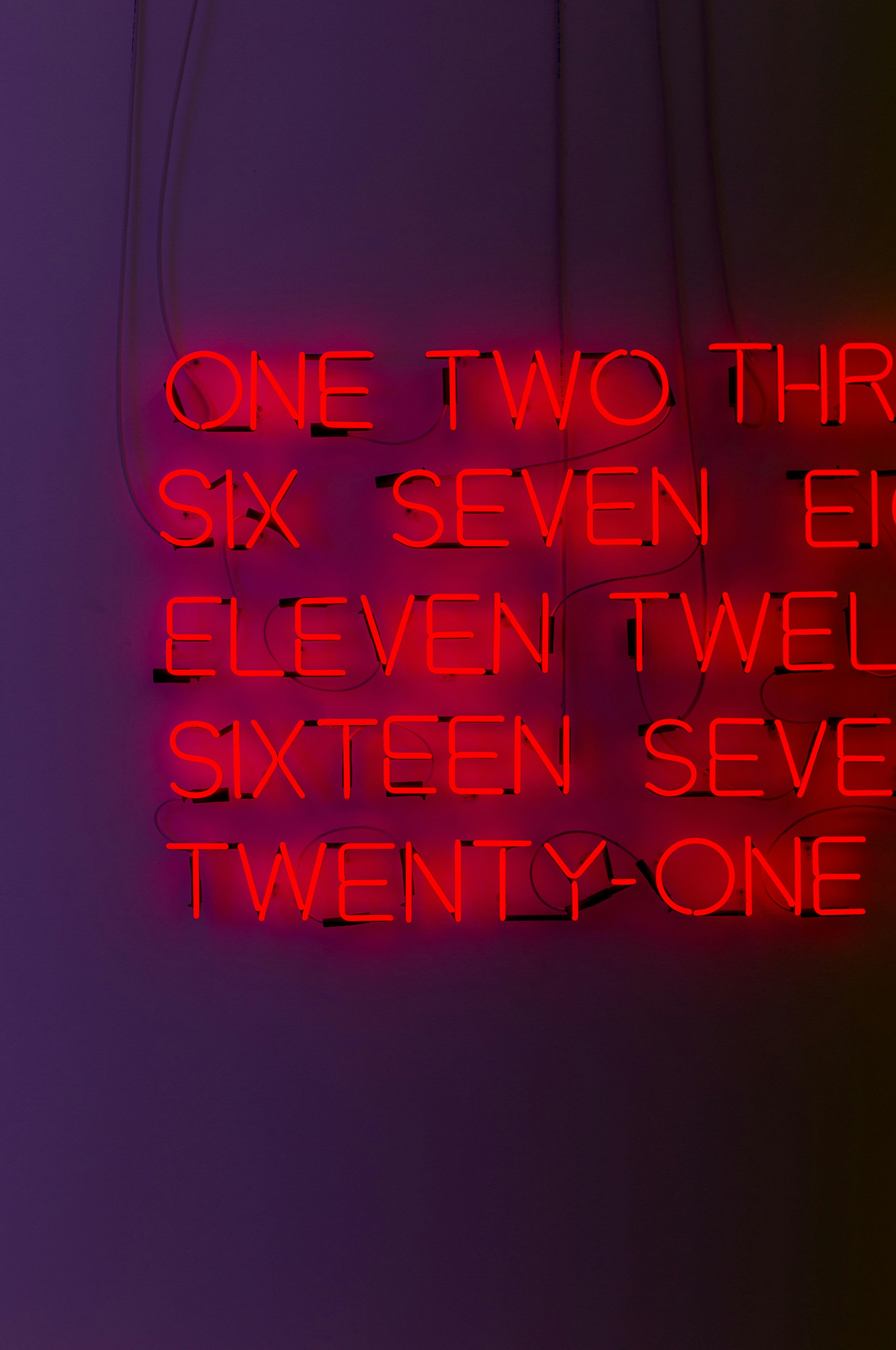 red neon numbers on a purple wall