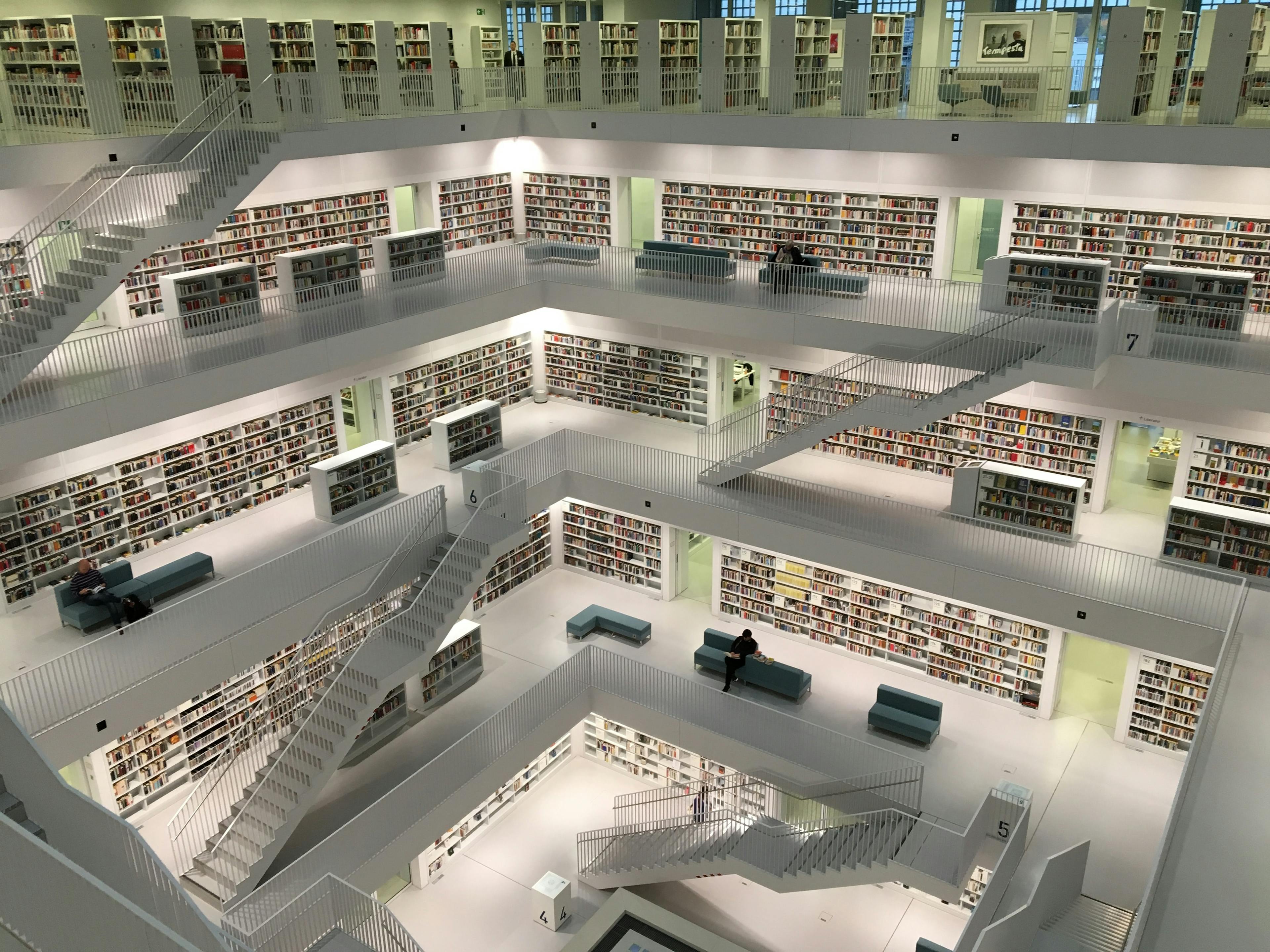 A multistory library with open modern architecture. Hundreds of books are in view.
